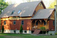 Bowed Roof Timber Frame Cape in Brownfield Maine