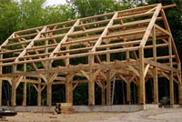Hybrid House combining timber frame core in a stick built house